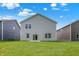 This backyard features a large lawn with a home in the background at 16929 Sandhurst Pl, Westfield, IN 46074