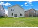 This backyard features a large lawn, a home, and a concrete patio at 16929 Sandhurst Pl, Westfield, IN 46074