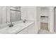 Modern bathroom featuring double sinks, quartz countertops, stylish fixtures, and a separate glass-enclosed shower at 16929 Sandhurst Pl, Westfield, IN 46074