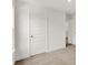This bedroom features neutral carpet, white walls, a paneled door, and white trim at 16929 Sandhurst Pl, Westfield, IN 46074