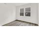 Bright bedroom featuring two windows, gray laminate floors, and white walls at 16929 Sandhurst Pl, Westfield, IN 46074