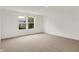 Bright bedroom with a window overlooking trees and carpeted floors at 16929 Sandhurst Pl, Westfield, IN 46074