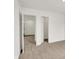This bedroom features neutral carpet and an open door into an adjacent room at 16929 Sandhurst Pl, Westfield, IN 46074