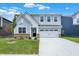 Charming two-story home with light-blue siding, white trim and a two car garage at 16929 Sandhurst Pl, Westfield, IN 46074