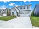Charming two-story home with light-blue siding, white trim and a two car garage at 16929 Sandhurst Pl, Westfield, IN 46074