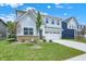Charming two-story home with light-blue siding, white trim and a two car garage at 16929 Sandhurst Pl, Westfield, IN 46074