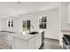 Modern kitchen featuring an island with seating, stainless steel appliances, and wood flooring at 16929 Sandhurst Pl, Westfield, IN 46074