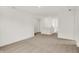 Open-concept living room with white walls, carpeted floors, and a view of the hallway at 16929 Sandhurst Pl, Westfield, IN 46074
