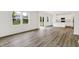 Open-concept living room adjacent to a modern kitchen with stainless steel appliances at 16929 Sandhurst Pl, Westfield, IN 46074