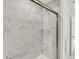 Modern bathroom shower showcasing marble tiling and a glass door with stainless steel hardware and door to outside room at 16929 Sandhurst Pl, Westfield, IN 46074