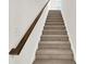 Carpeted stairway with a dark wood railing and white walls at 16929 Sandhurst Pl, Westfield, IN 46074