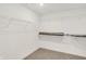 Spacious walk-in closet with wire shelving and neutral carpeting, ready for organizing your wardrobe and accessories at 16929 Sandhurst Pl, Westfield, IN 46074