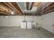 Unfinished basement area with concrete floor, exposed ceiling, laundry hookups and painted walls at 171 Nursery Rd, Anderson, IN 46012