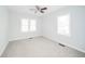 This bedroom has carpeted floors and multiple windows that provide lots of natural light and a ceiling fan at 171 Nursery Rd, Anderson, IN 46012