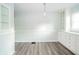 Dining area featuring built-in cabinets, contemporary lighting, and updated vinyl flooring at 171 Nursery Rd, Anderson, IN 46012
