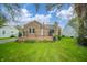 Charming stone-accented home featuring a cozy front porch and a well-maintained green lawn at 171 Nursery Rd, Anderson, IN 46012