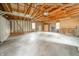 Spacious unfinished garage with wood beams and walls, large windows and concrete floor at 171 Nursery Rd, Anderson, IN 46012