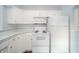 Well-lit kitchen with white appliances and cabinets that offer ample storage space and counter space at 171 Nursery Rd, Anderson, IN 46012