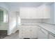 Bright kitchen features white cabinets, appliances and an arched doorway leading to another room at 171 Nursery Rd, Anderson, IN 46012