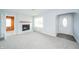 Bright and airy living room with a cozy fireplace, new carpet, and ample natural light at 171 Nursery Rd, Anderson, IN 46012
