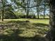 A serene backyard with mature trees and a firepit at 1725 E 100 S, Lebanon, IN 46052