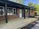 Newly constructed wooden front porch and red brick exterior enhance this home's curb appeal at 1725 E 100 S, Lebanon, IN 46052