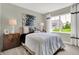 Bedroom featuring neutral walls, carpet, large window, lamps, nightstands and decorated bed at 19838 Moorpark Lndg, Noblesville, IN 46062