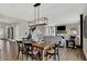 Open floor plan with a wooden dining table, a view of the living room, and lots of natural light at 19838 Moorpark Lndg, Noblesville, IN 46062