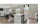 Open concept kitchen with stainless steel dishwasher, eat-in kitchen with dining table, and lots of natural light at 19838 Moorpark Lndg, Noblesville, IN 46062