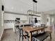 Spacious kitchen with white cabinets, stainless appliances, breakfast bar island, and adjacent dining area at 19838 Moorpark Lndg, Noblesville, IN 46062