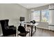 Bright office with neutral walls, wood floors, glass desk and large windows at 19838 Moorpark Lndg, Noblesville, IN 46062