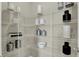 Pantry with many white wire racks, a variety of ceramic containers, and modern decor elements at 19838 Moorpark Lndg, Noblesville, IN 46062