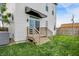 Back exterior of home features a wooden deck with stairs and grassy yard at 2008 Yandes St, Indianapolis, IN 46202