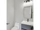 Modern bathroom features sleek vanity with a black faucet, toilet, and rectangular mirror at 2008 Yandes St, Indianapolis, IN 46202