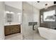 Modern bathroom featuring a glass-enclosed shower, soaking tub, and double vanity with contemporary fixtures at 2008 Yandes St, Indianapolis, IN 46202