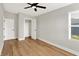 Bright, bedroom featuring hardwood floors, a modern ceiling fan and a walk-in closet at 2008 Yandes St, Indianapolis, IN 46202