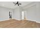 Bright, spacious bedroom featuring hardwood floors, a modern ceiling fan, and a walk-in shower at 2008 Yandes St, Indianapolis, IN 46202