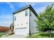 Modern two-story home featuring a front-facing garage, stylish siding, and a landscaped lawn at 2008 Yandes St, Indianapolis, IN 46202