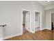 Hallway featuring hardwood floors leads to the laundry room and a bathroom at 2008 Yandes St, Indianapolis, IN 46202