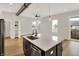 Kitchen island with stainless sink and faucet sits in an open concept space with hardwood floors and a ceiling fan at 2008 Yandes St, Indianapolis, IN 46202