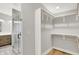 Walk-in closet with custom shelving with a full bathroom next door at 2008 Yandes St, Indianapolis, IN 46202