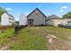 Backyard view of the home, including a gray exterior and newly-seeded yard at 206 N Beville Ave, Indianapolis, IN 46201