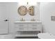 Bathroom with a double sink vanity, round mirrors and modern fixtures at 206 N Beville Ave, Indianapolis, IN 46201