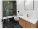 Bathroom featuring unique tiling in shower and wood vanity with white sink at 206 N Beville Ave, Indianapolis, IN 46201