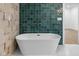 A modern standalone bathtub is surrounded by colorful tiling at 206 N Beville Ave, Indianapolis, IN 46201