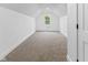 Bright bedroom features clean white walls, neutral carpet, and a window bringing in natural light at 206 N Beville Ave, Indianapolis, IN 46201