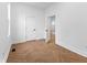 An empty bedroom features wood flooring, white walls and two doors at 206 N Beville Ave, Indianapolis, IN 46201