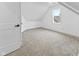 Finished attic bedroom featuring carpeted floors and a window at 206 N Beville Ave, Indianapolis, IN 46201
