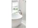 Freestanding bathtub by a window with city views and a modern faucet at 214 E St Joseph St, Indianapolis, IN 46202