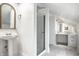 Modern bathroom showcasing a pedestal sink and glass shower, accented by decorative mirror and tile work at 214 E St Joseph St, Indianapolis, IN 46202